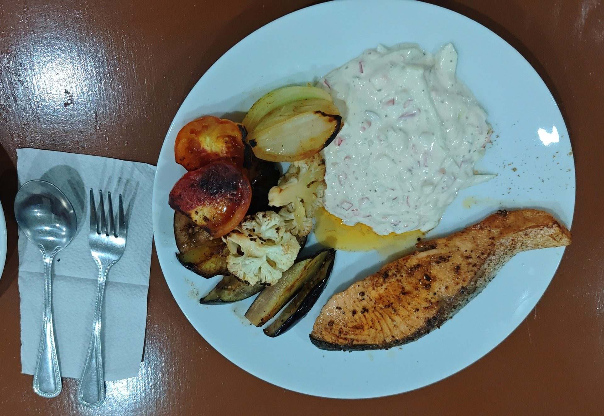 Grilled salmon steak served with steamed vegetables